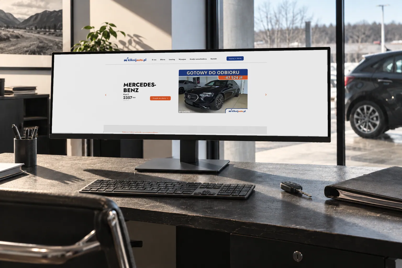 KliknijAuto — the website on a monitor