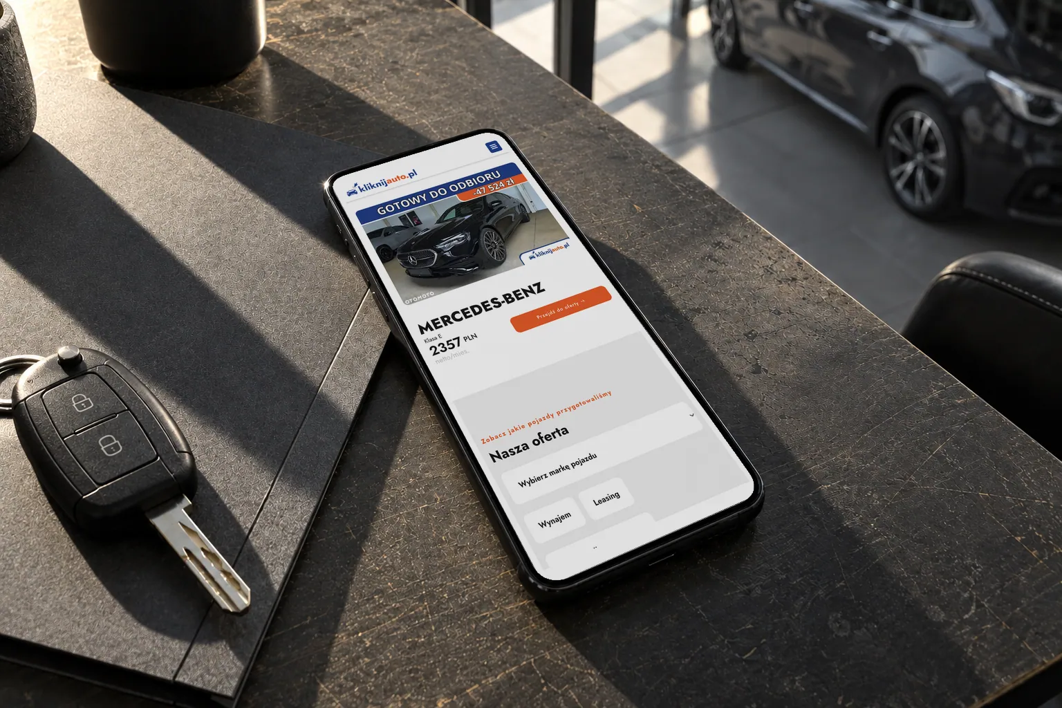 KliknijAuto — the website on a phone